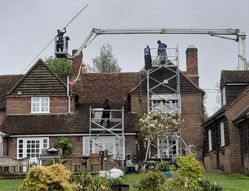 The Roof Moss Cleaners using cherry picker and scaffolding to clean roof safely and professionally in Hurstpierpoint, West Sussex